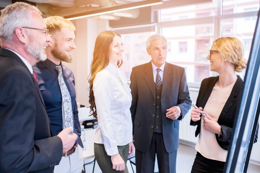 group-business-colleagues-looking-young-businesswoman-giving-presentation_23-2147923444